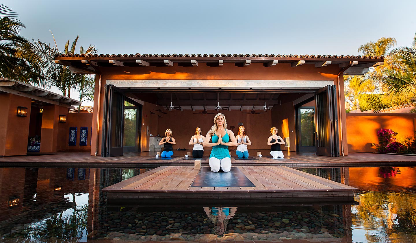 Women doing yoga in yoga pavilion at Rancho Valencia Spa resort in Southern California
