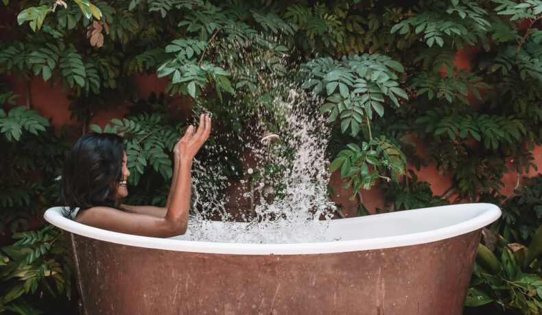 Person splashing in copper tub