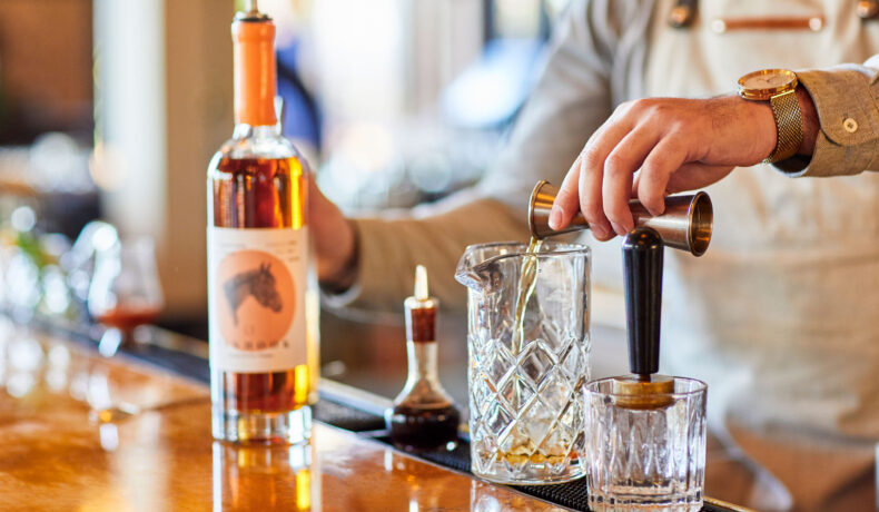 close up of bartender mixing a drink in the Pony Room