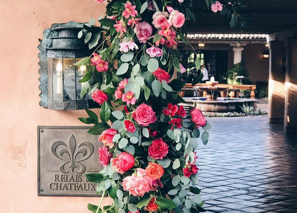 relais & chateux sign with lantern and pink flowers