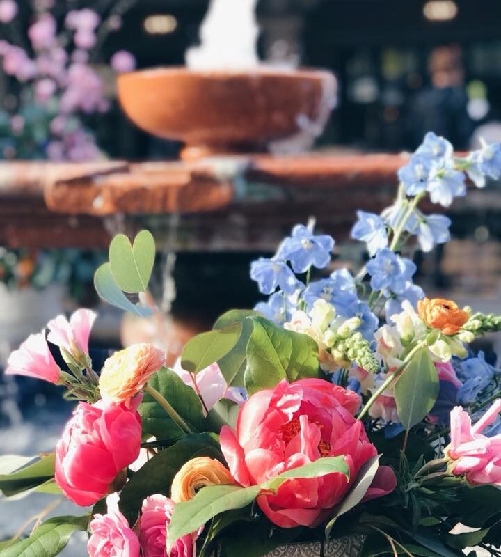 bouquet of flowers in front of outdoor fountain