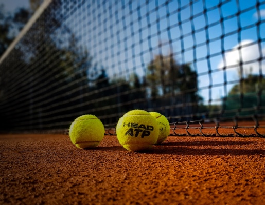 tennis balls on clay court