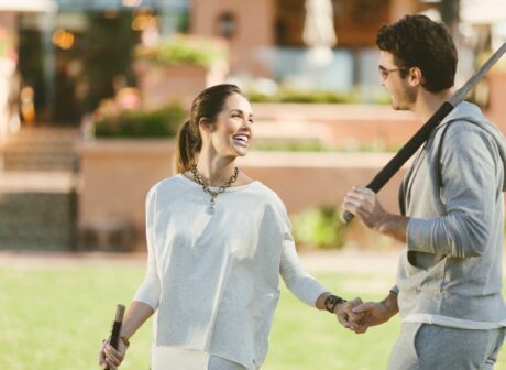 Couple Playing Tennis holing hands