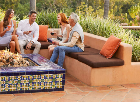 People sitting around an outdoor table laughing