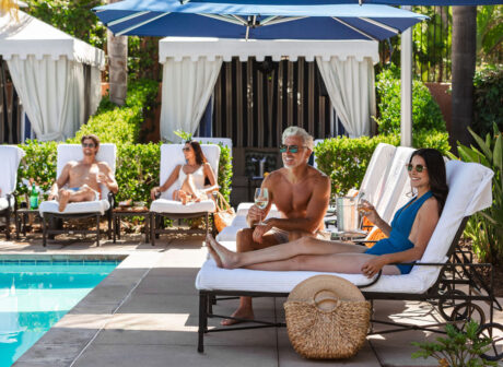 two couples lounging poolside at the spa