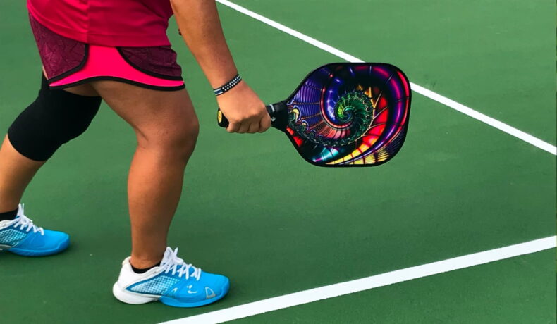 Pickleball player with a colorful racket