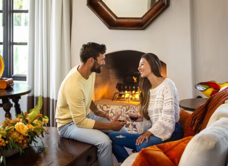romantic couple in guest casita in front of fireplace