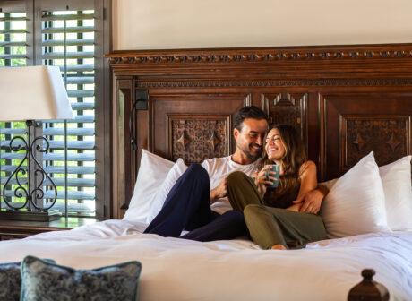 Couple snuggling on bed in casita