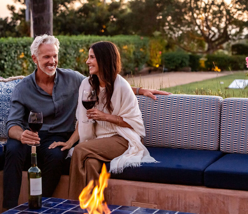 Couple drinking wine at firepits
