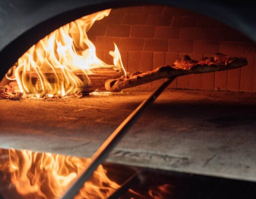 Wood Fired Pizza being pulled from oven