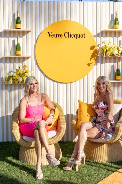 Ladies sitting in front of the Veuve photo activation at the After Pony Party
