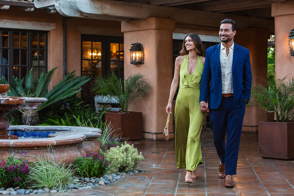 couple holding hands on fountain courtyard