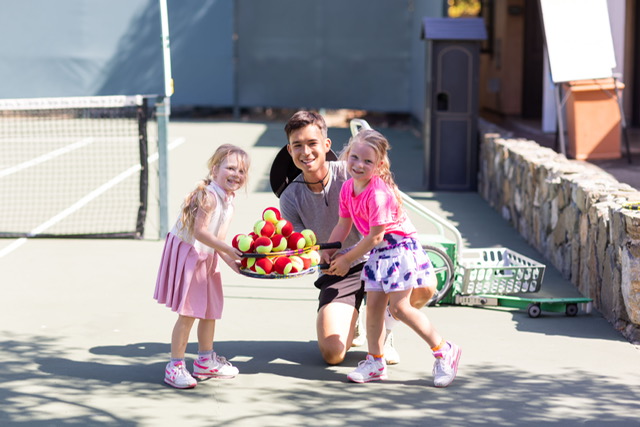 Junior Tennis Pro with two young girls