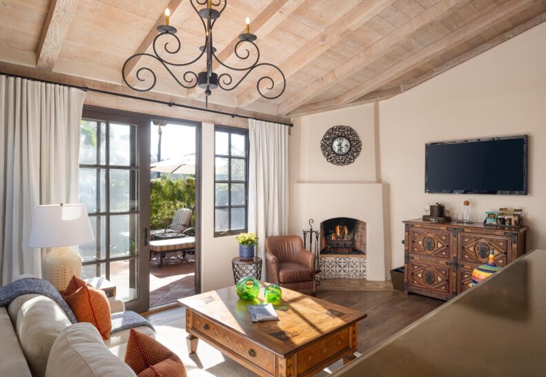Agave Suite Two Queen sunken living area with indoor fireplace and open door to patio