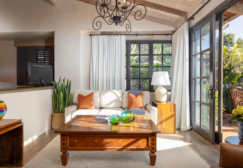 Agave Suite Two Queen Living Area with couch and coffee table, and open door to patio