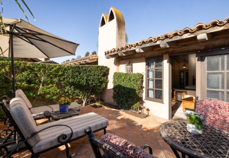 Eucalyptus ADA Two Queen Suite Patio with loungers and table/chairs