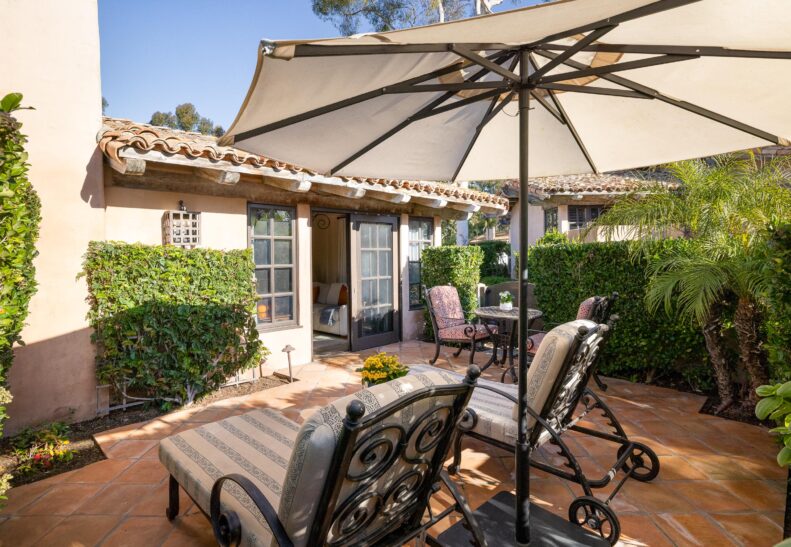 Eucalyptus ADA Two Queen Suite Patio with loungers and table/chairs