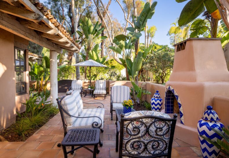 Palm Suite Patio with loungers and outdoor fireplace