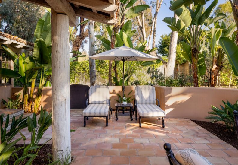 Palm Suite patio with loungers and small table