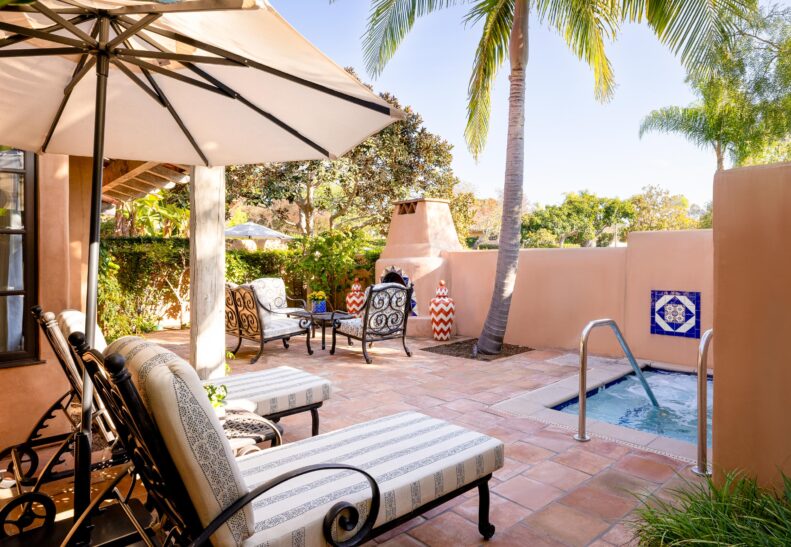 Valencia Suite 150 Patio with loungers, whirlpool, and fireplace